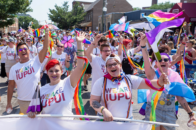 IUPUI supporters march along Massachusetts Avenue during the Indy Pride parade.