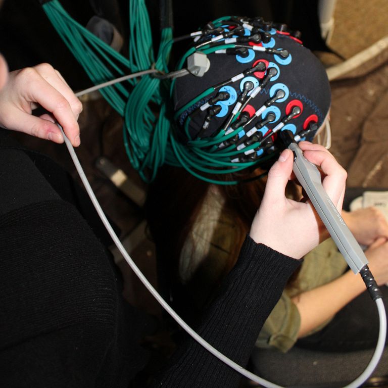 A volunteer wears a cap that scans the brain functional near-infrared spectroscopy.