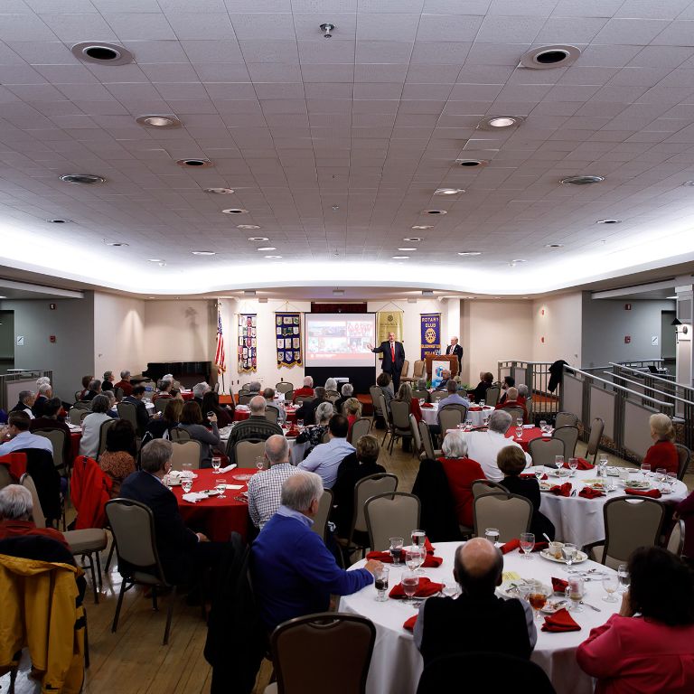 An audience of around 75 Bloomington Rotarians listens to IU President McRobbie's speech