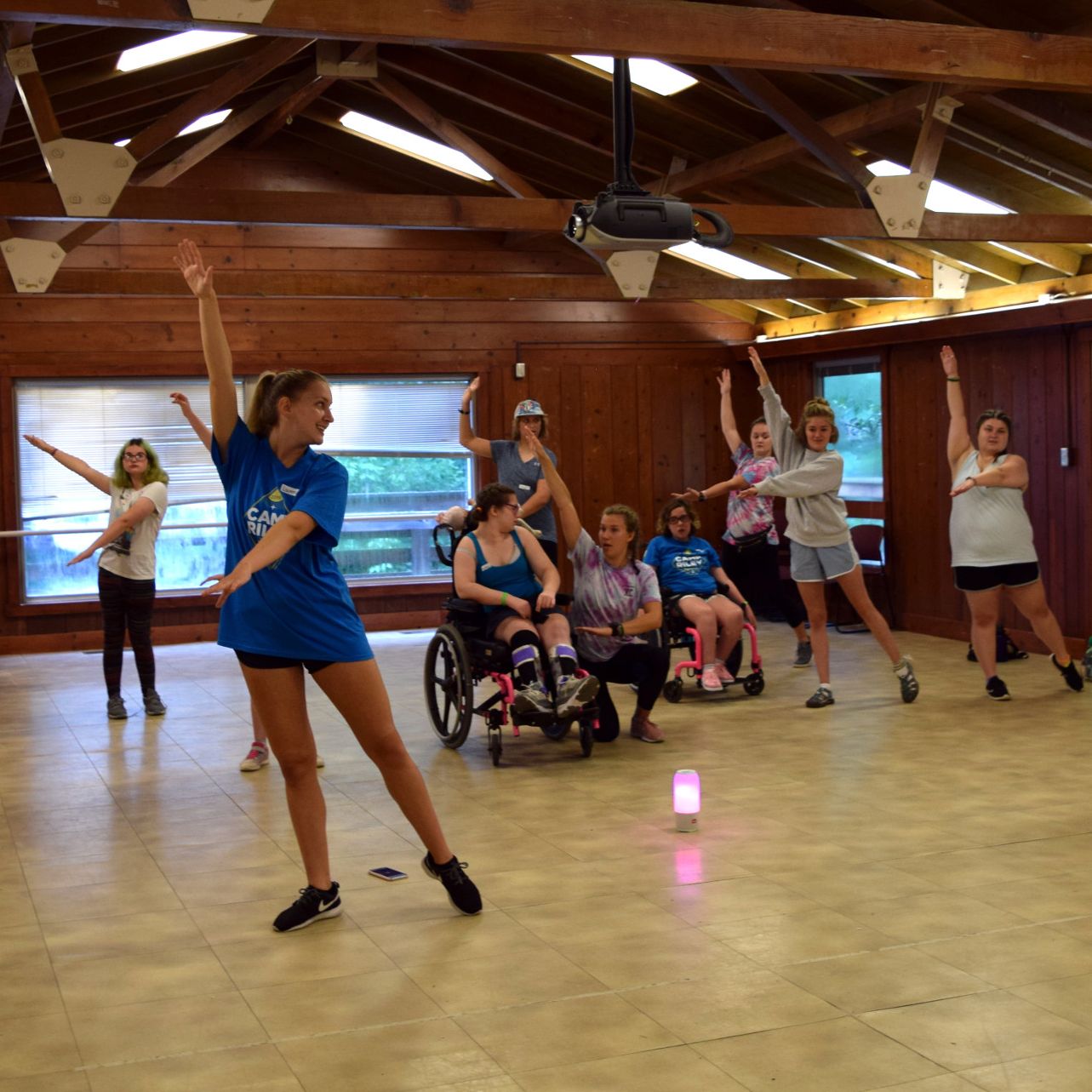 Campers practice pointing their toes and holding their arms aloft