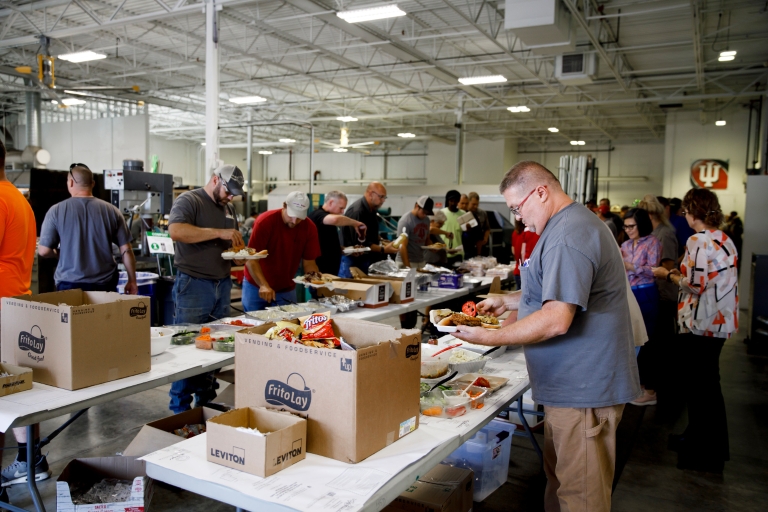 Staff get food at the Capital Planning and Facilities annual picnic