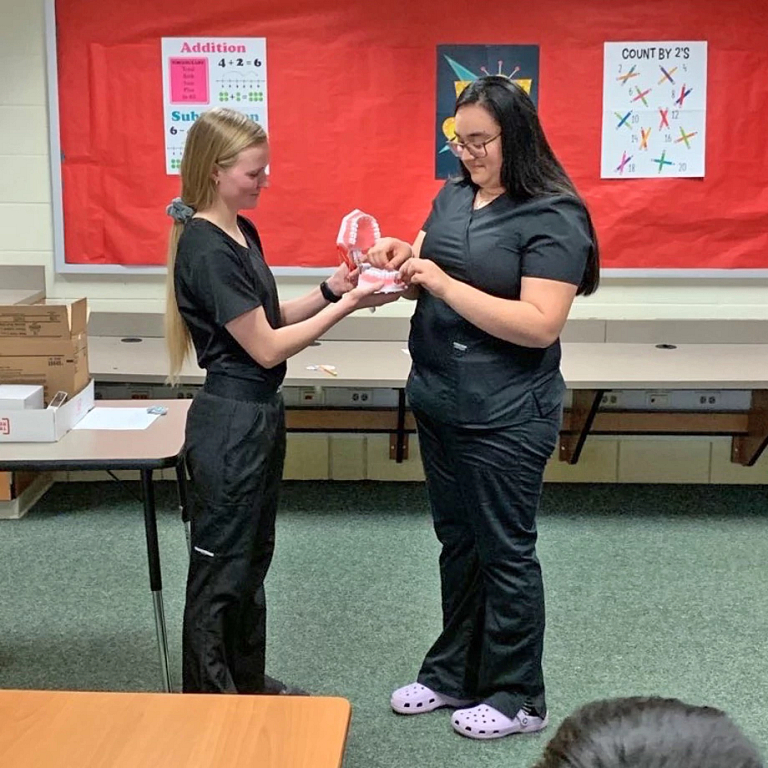 Two IU students deliver a presentation on oral health to fourth graders in Richmond, Ind.