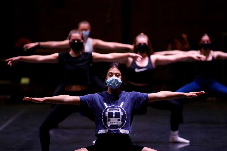 Dancers practice while wearing masks