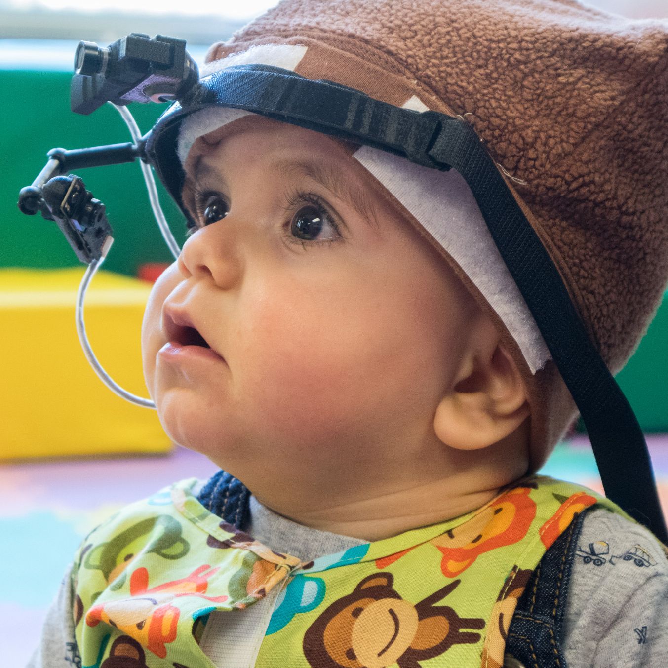 Child wears head-mounted camera. 