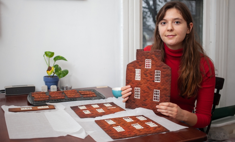 Mary Figueroa works on a gingerbread house 