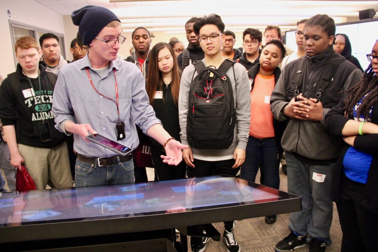 Advanced Visualization Lab worker shows iDEW students an IQ-Table.