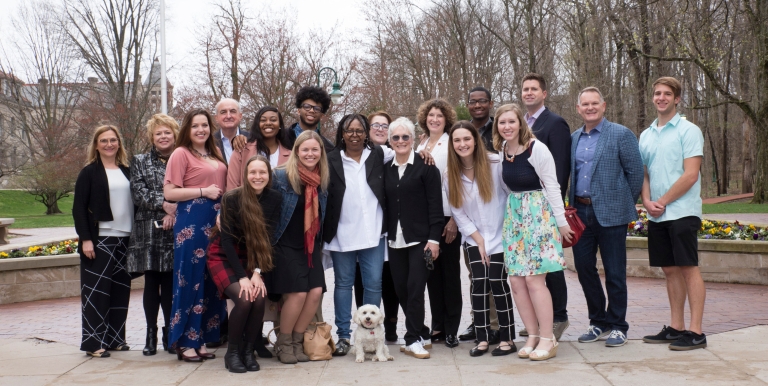 Glenn Close and Whoopi Goldberg posing with students at Sample Gates. 