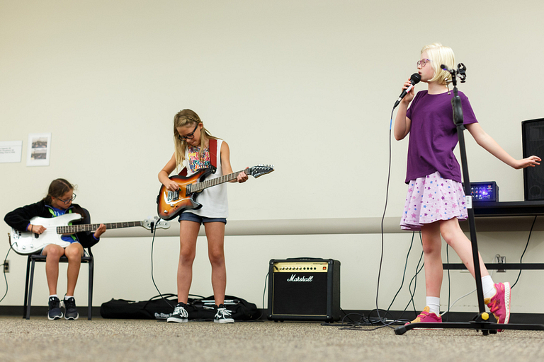 Girls performing at a rehearsal during Girls Rock camp.